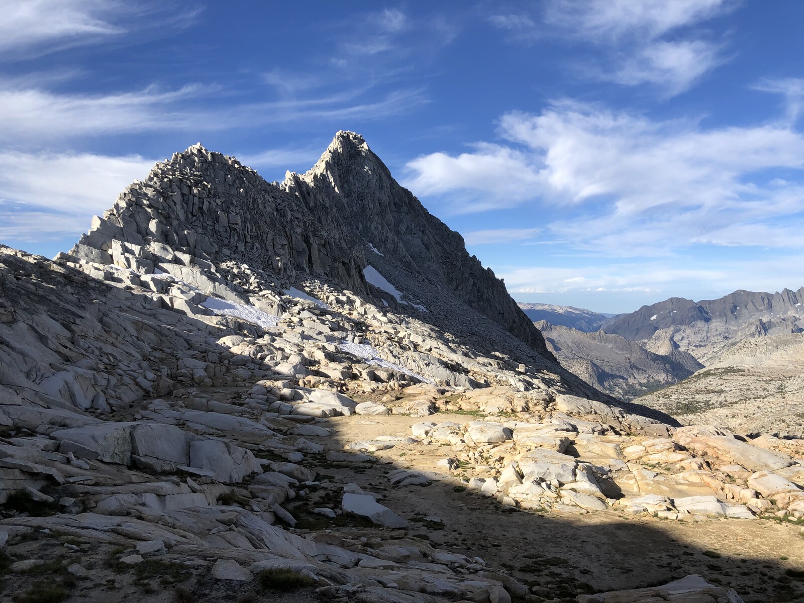 Rugged granite cirque basin with jagged peaks and sparse vegetation