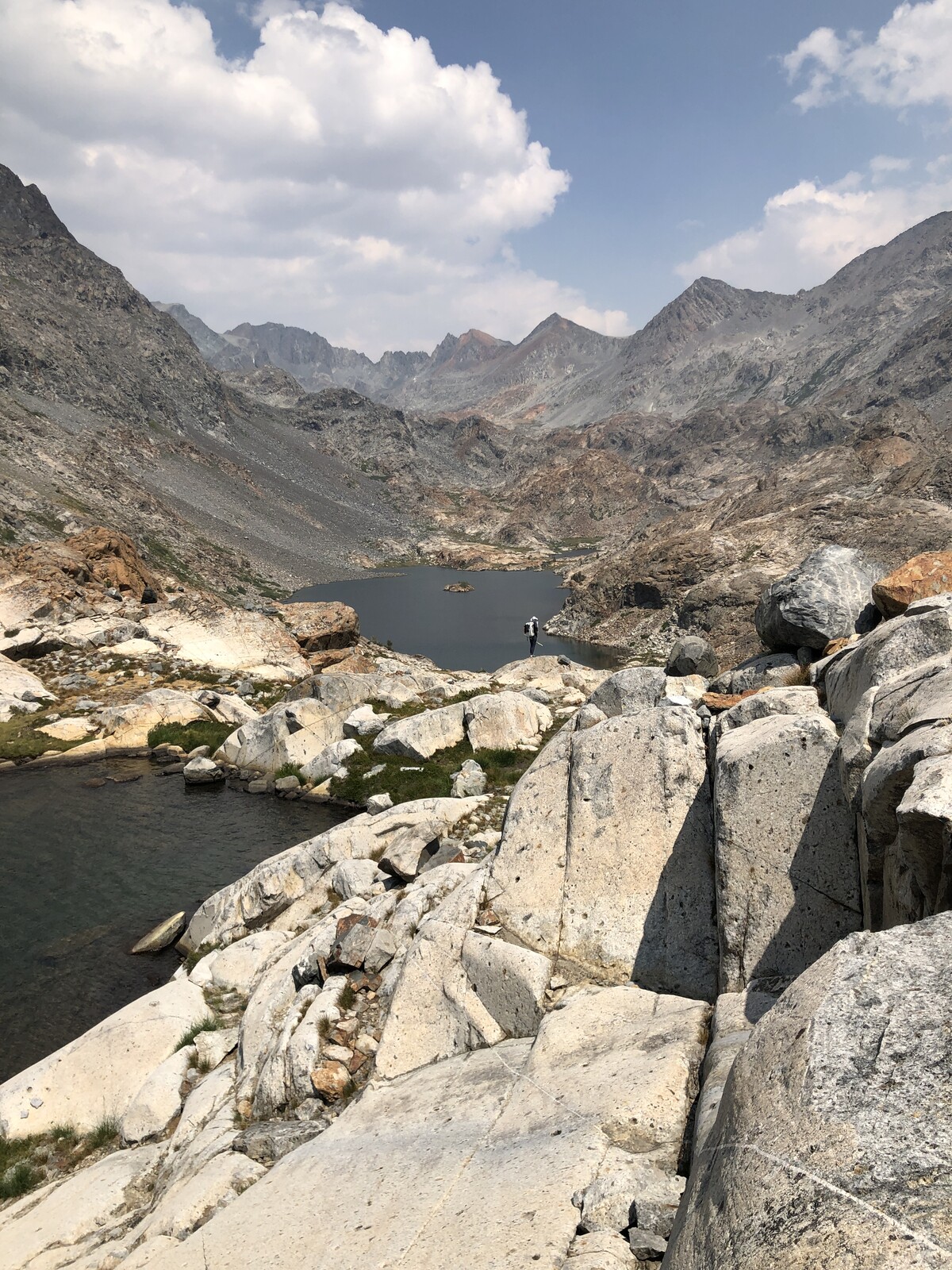 Alpine lake reflecting surrounding mountains perfectly still