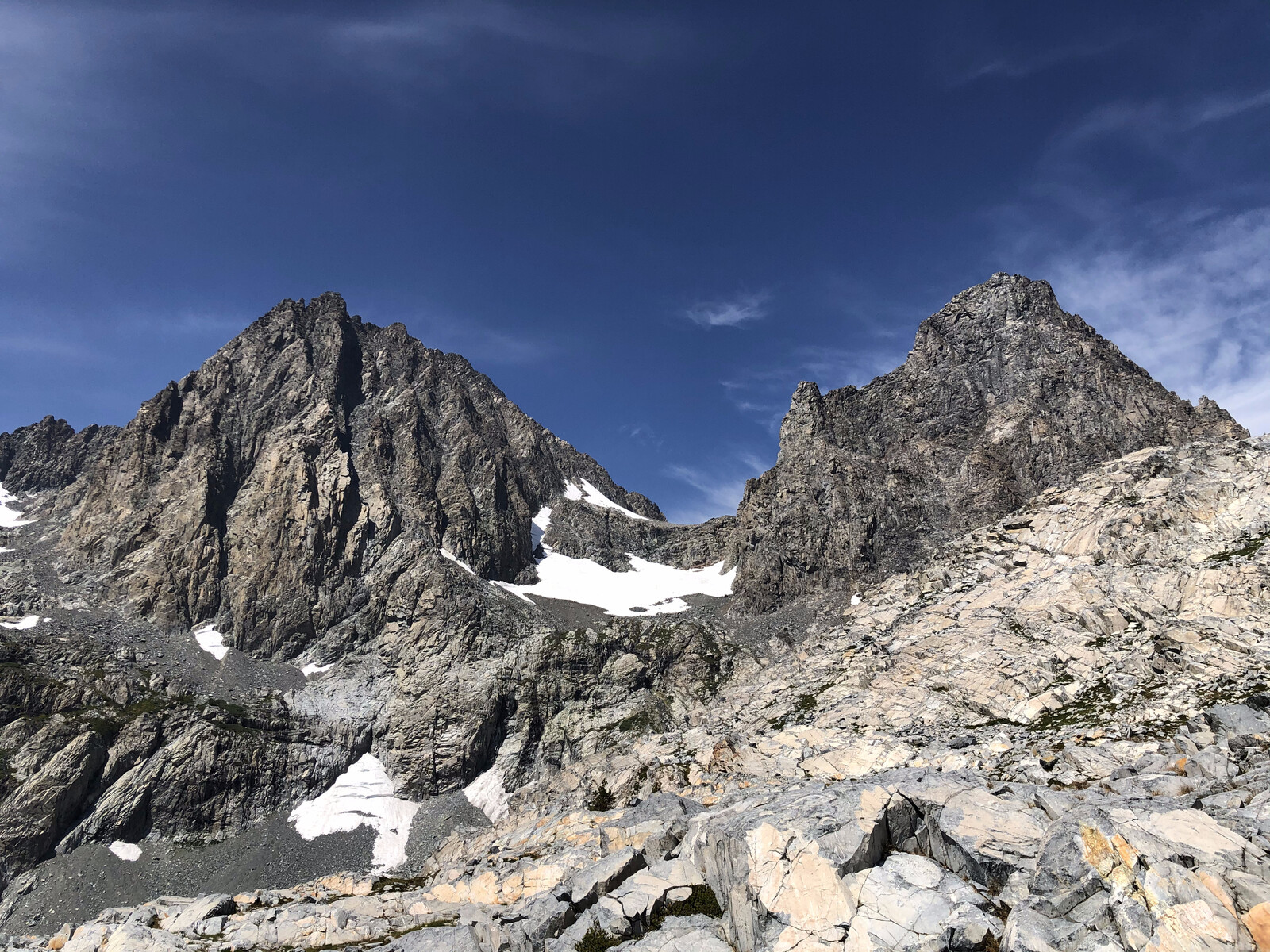 Twin rocky peaks with glacier remnants between them
